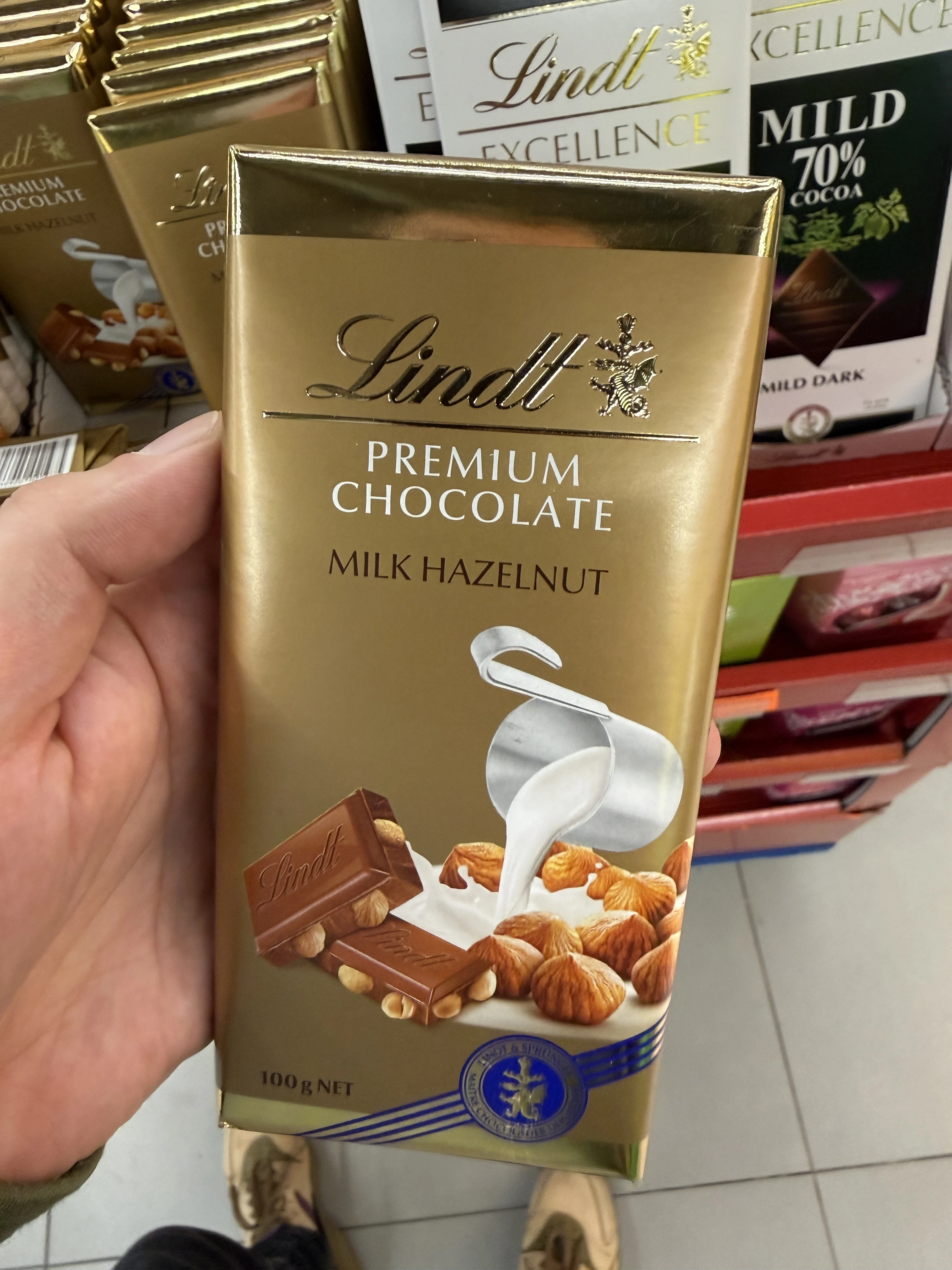 Lindt Premium Chocolate Milk Hazelnut / Szwajcarska mleczna czekolada z całymi prażonymi orzechami laskowymi | 100g